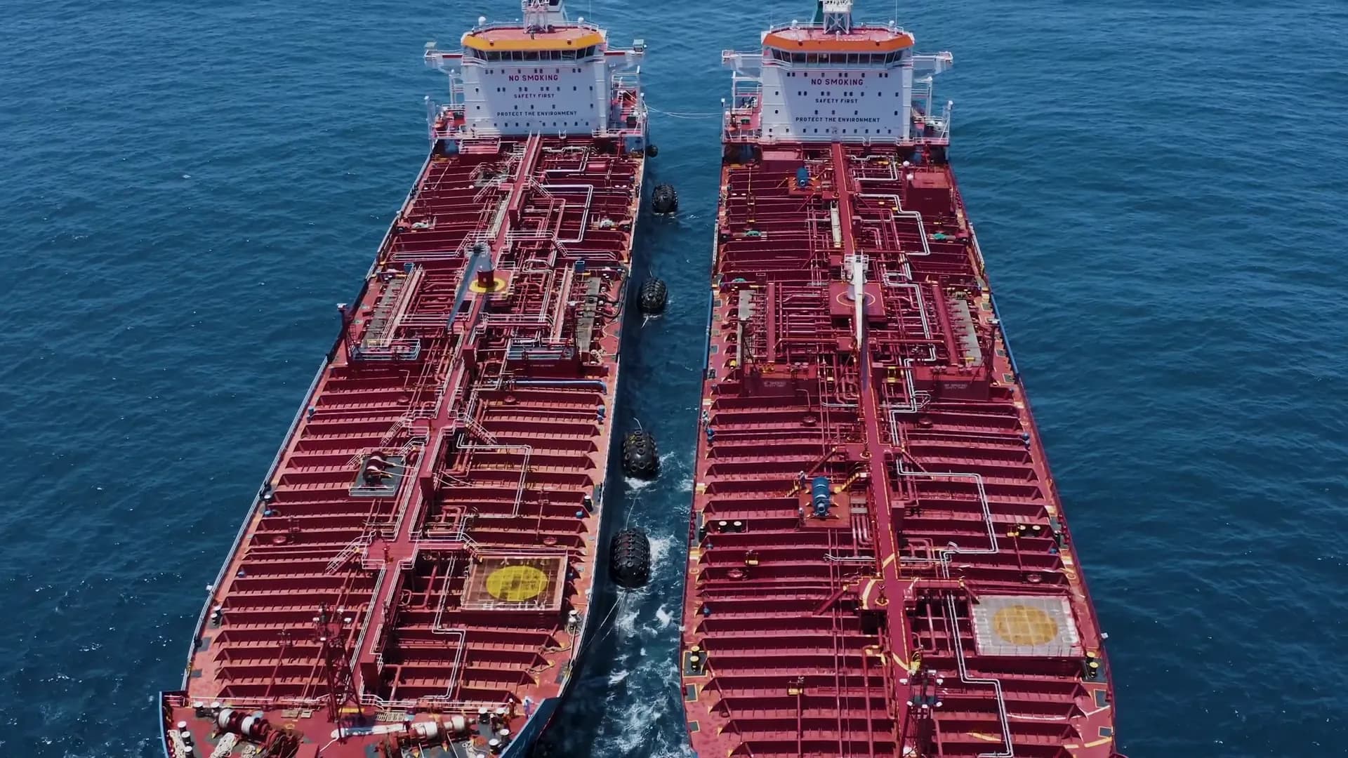 Top-down view of two tankers moored alongside during a transfer